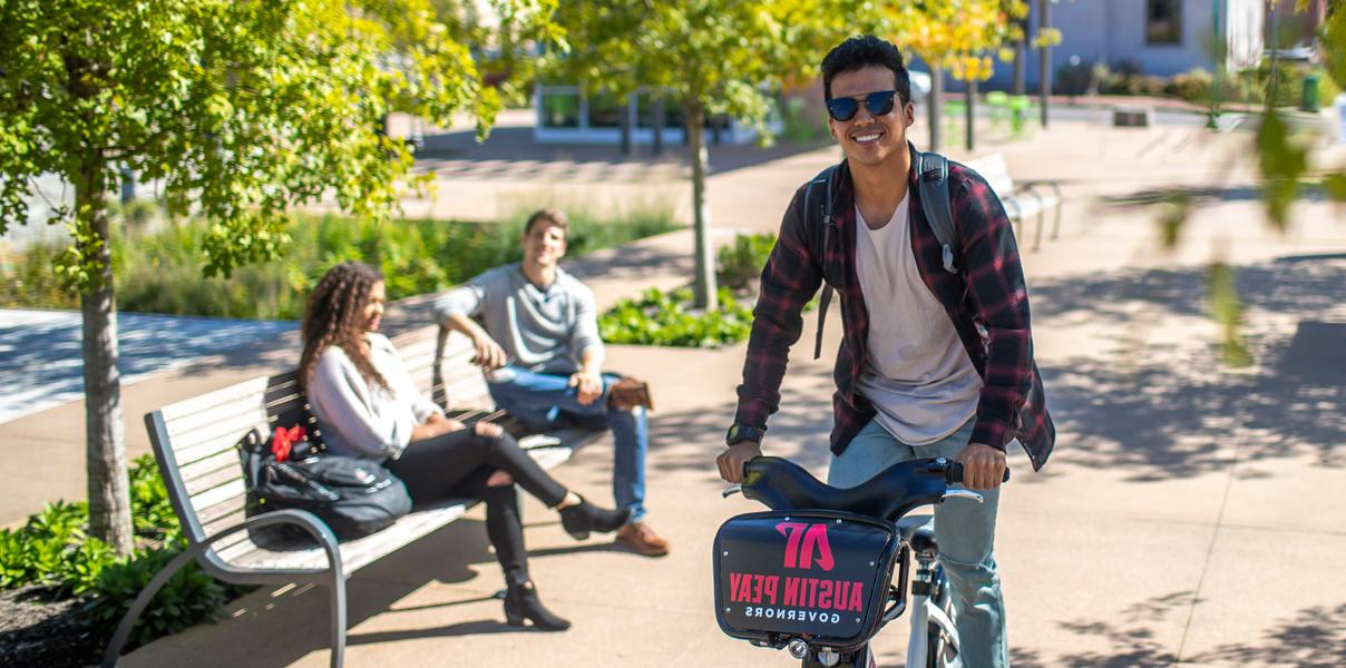 Student riding a bike downtown